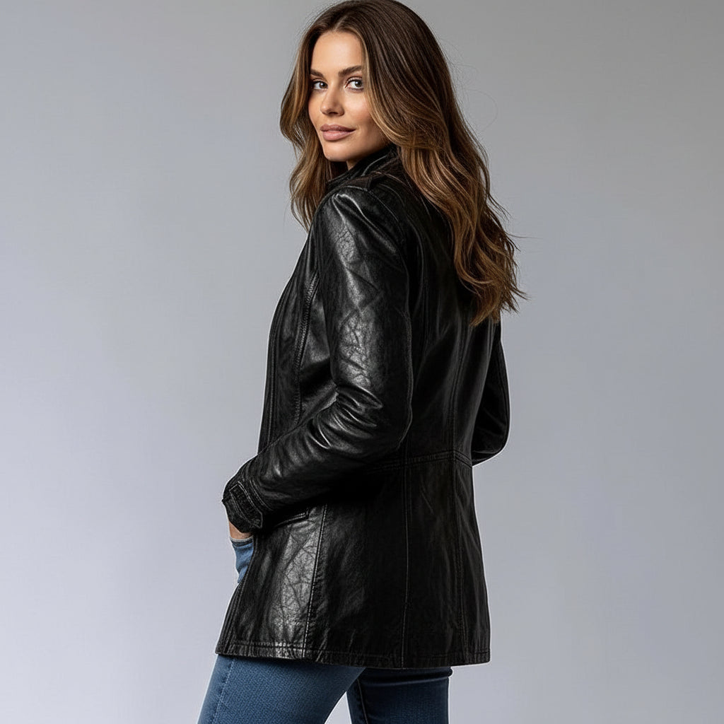 Person wearing a black leather jacket on a gray background
